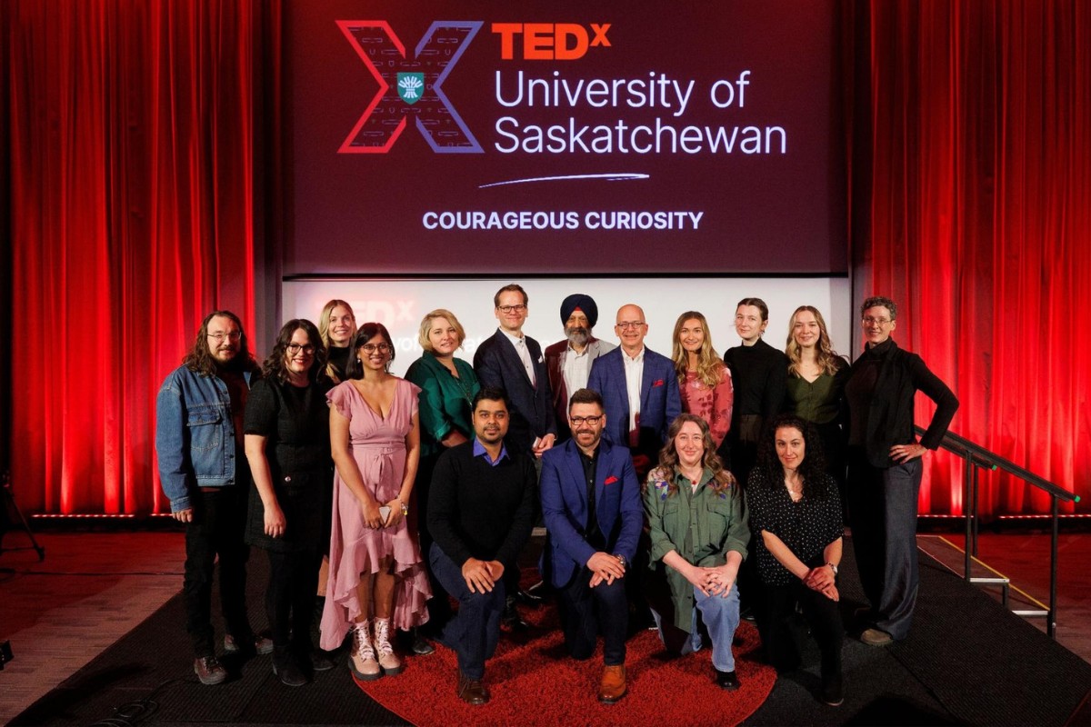 USask's VP Research Baljit Singh stands on the TEDxUniversityofSaskatchewan stage with the 2024 speakers, performer and planning committee.